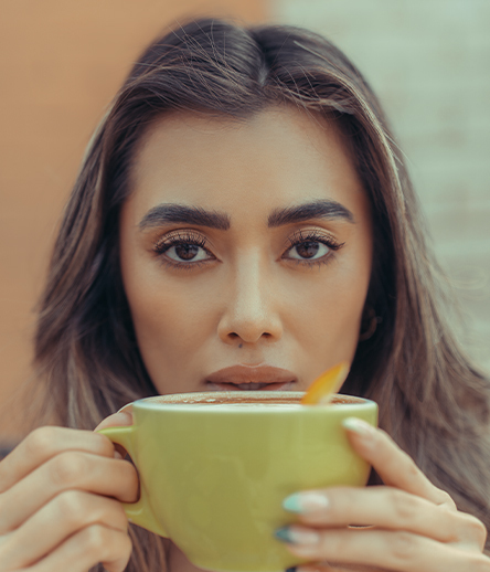 Woman sipping from a coffee cup